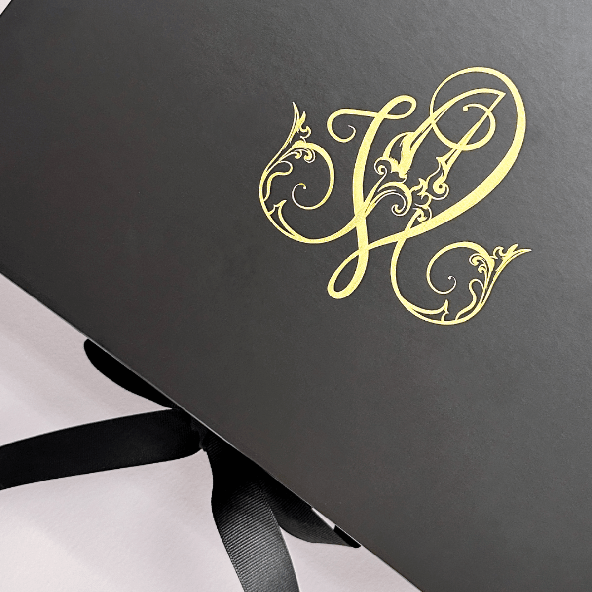 black gift box with custom print in gold foil for St Regis Hotel