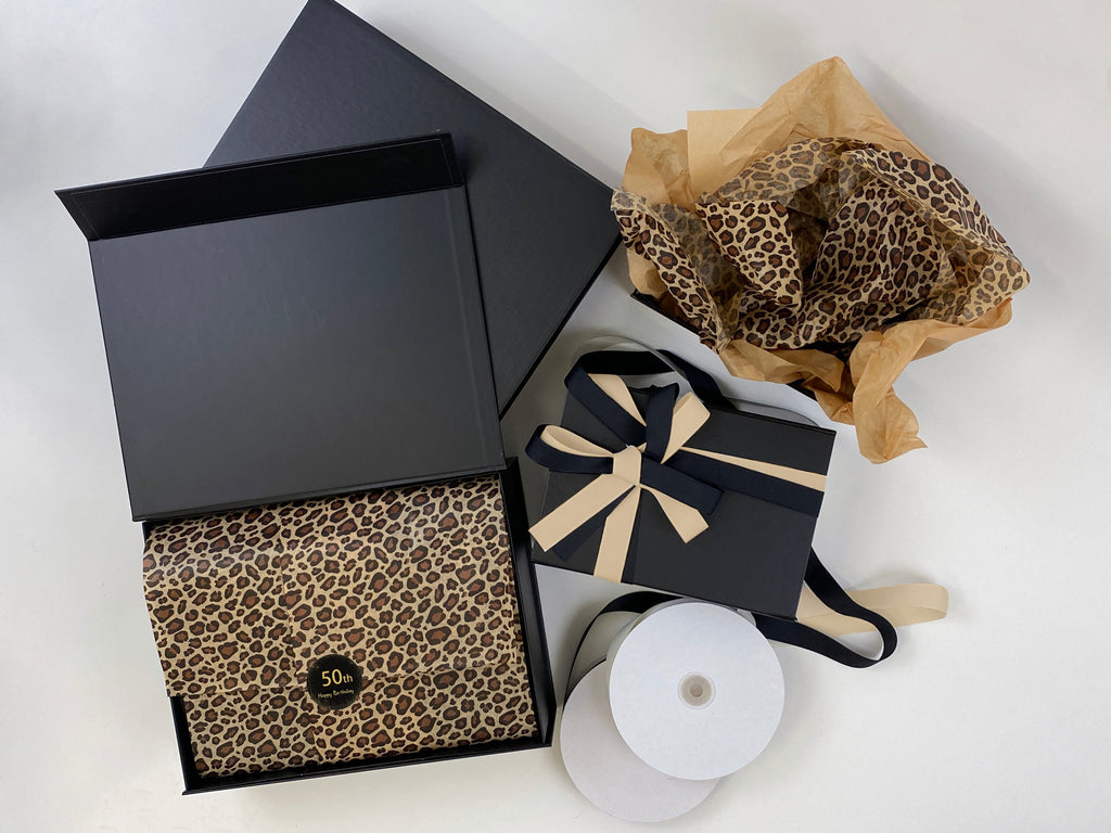 black magnetic gift boxes with leopard tissue paper and grosgrain ribbon