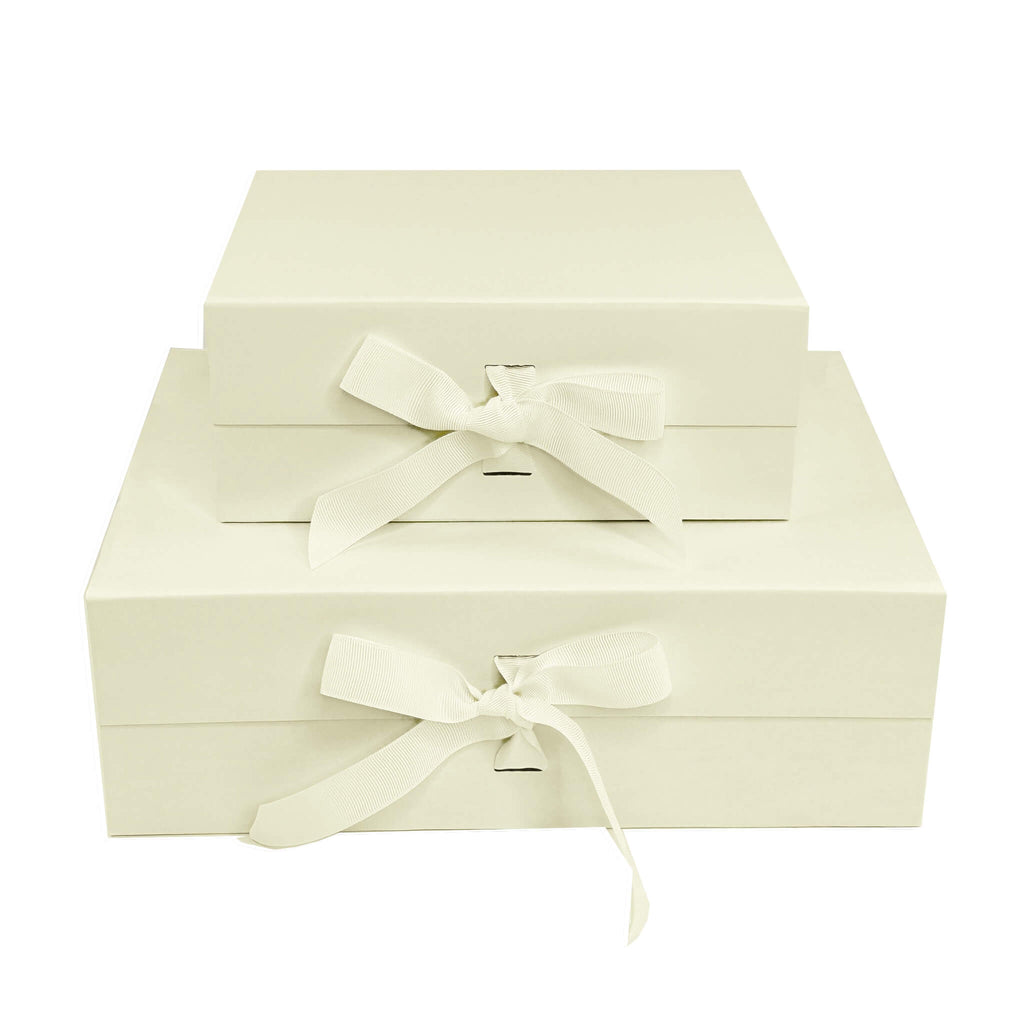 Ivory foldable magnetic gift boxes with changeable ribbon stacked in two sizes small and medium 