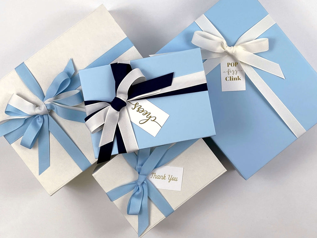 magnetic closure gift boxes in powder blue and ivory with grosgrain ribbon and custom gift tags
