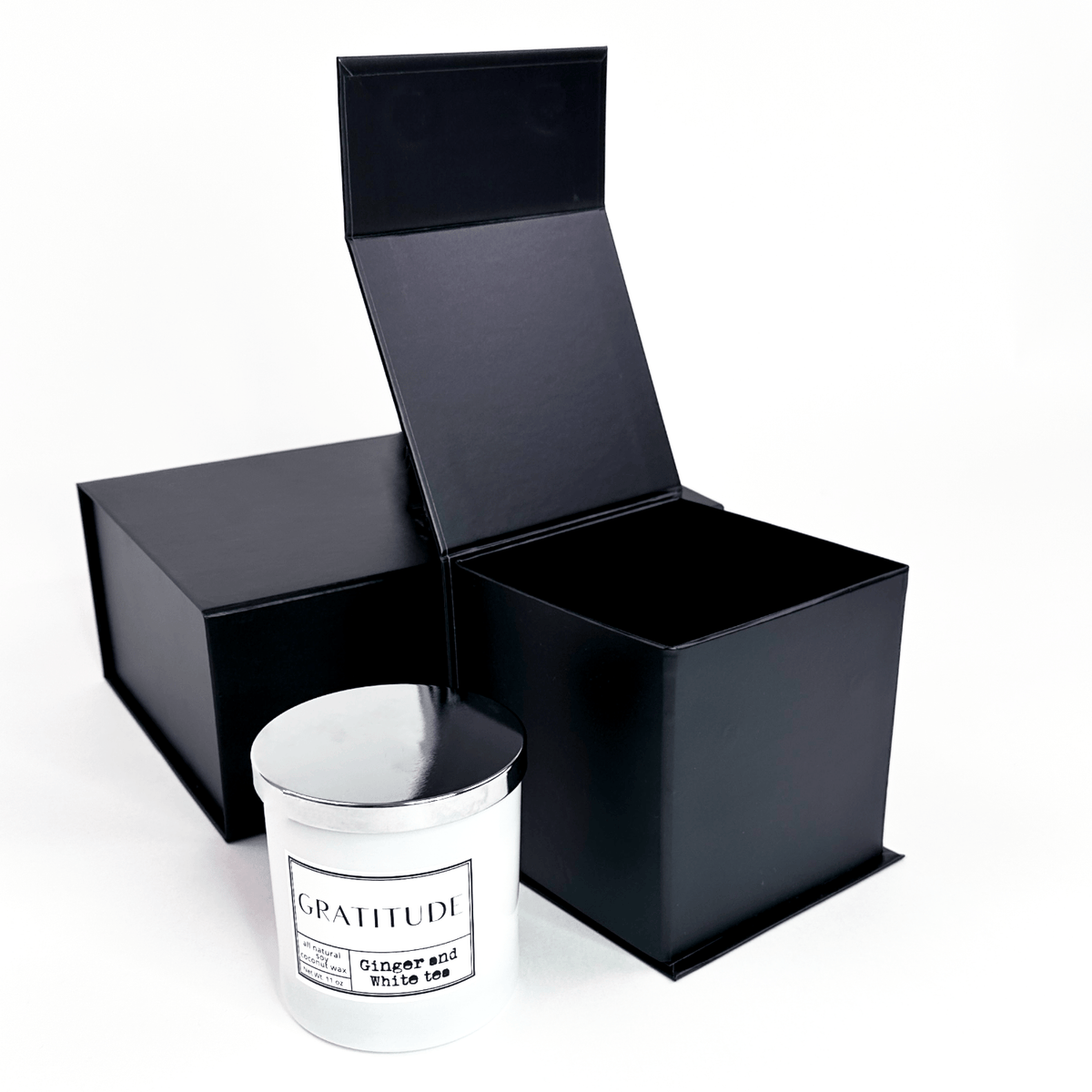 small cube gift box with magnetic closure open with candle 