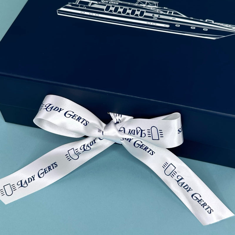 Navy gift box finished with a white custom printed satin ribbon
