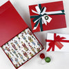 red gift box with green and white ribbon and nutcracker tissue